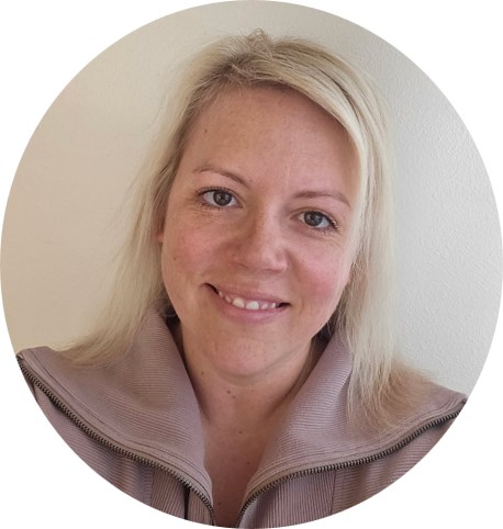Alyssa Sullivan, Human Resources Director at American Solutions for Business, smiles at the camera. She has light blonde hair, fair skin, and wears a light jacket against a plain background. The image is framed in a circular shape.