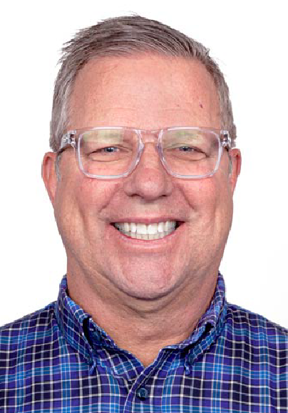 A middle-aged man with short gray hair, wearing clear-framed glasses and a blue plaid shirt, smiles broadly against a plain white background as he celebrates being one of the ASB Advisory Board Members.